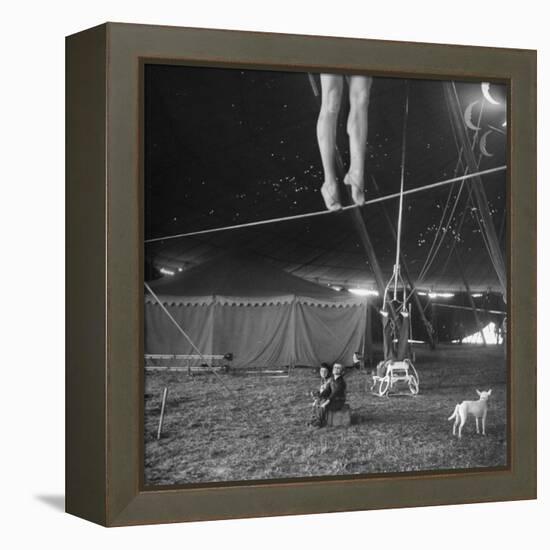 Two Small Children Watching Circus Performer Practicing on Tightrope, Her Legs Only Visible-Nina Leen-Framed Premier Image Canvas