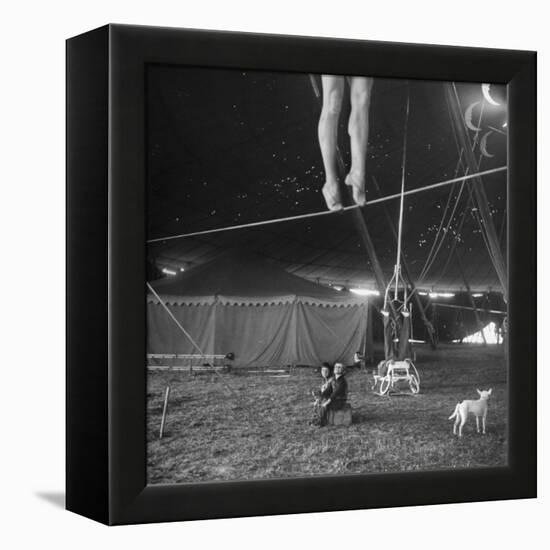 Two Small Children Watching Circus Performer Practicing on Tightrope, Her Legs Only Visible-Nina Leen-Framed Premier Image Canvas