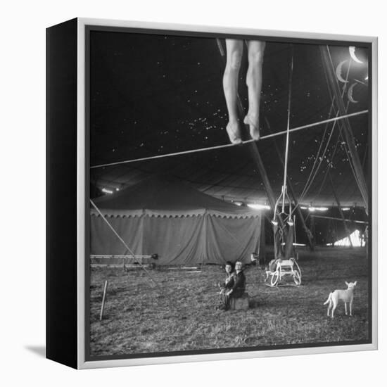 Two Small Children Watching Circus Performer Practicing on Tightrope, Her Legs Only Visible-Nina Leen-Framed Premier Image Canvas