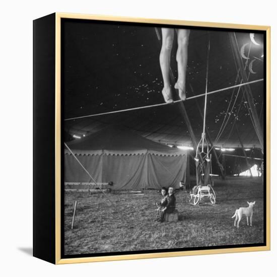 Two Small Children Watching Circus Performer Practicing on Tightrope, Her Legs Only Visible-Nina Leen-Framed Premier Image Canvas