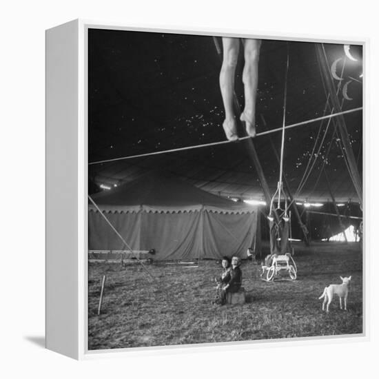 Two Small Children Watching Circus Performer Practicing on Tightrope, Her Legs Only Visible-Nina Leen-Framed Premier Image Canvas