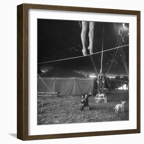 Two Small Children Watching Circus Performer Practicing on Tightrope, Her Legs Only Visible-Nina Leen-Framed Photographic Print