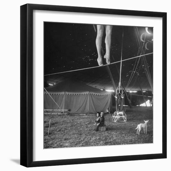 Two Small Children Watching Circus Performer Practicing on Tightrope, Her Legs Only Visible-Nina Leen-Framed Photographic Print