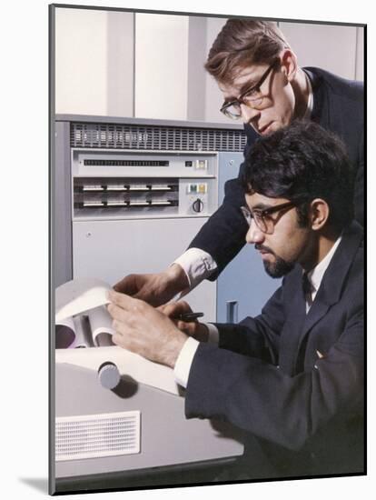 Two Technicians Check a Computer Printout-Heinz Zinram-Mounted Photographic Print