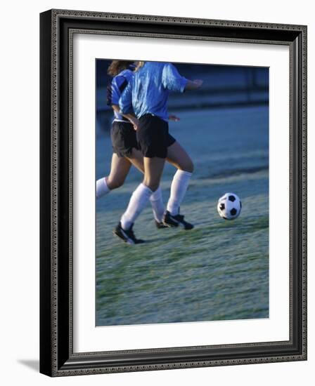 Two Teenage Girls Running for a Soccer Ball-null-Framed Photographic Print