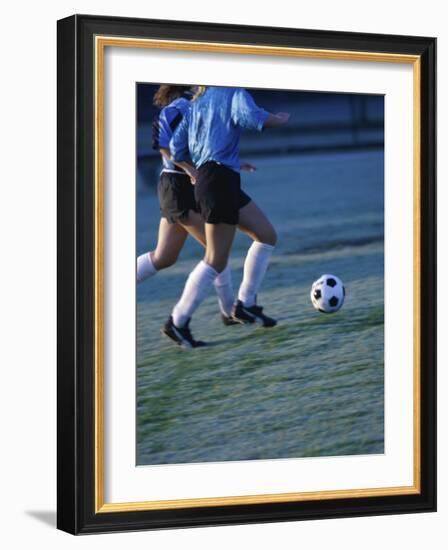 Two Teenage Girls Running for a Soccer Ball-null-Framed Photographic Print