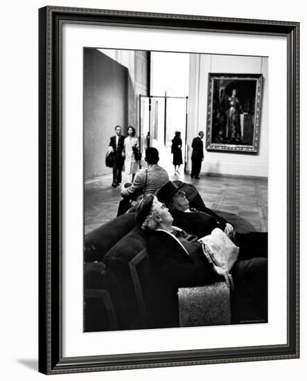 Two Weary American Tourists Resting on Sofa in Gallery of the Louvre-Alfred Eisenstaedt-Framed Photographic Print