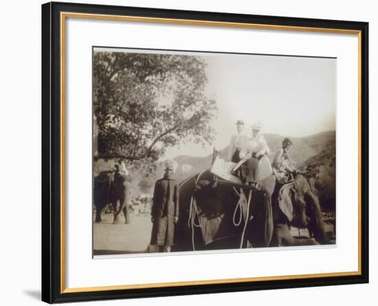 Two Well-Dressed English Women Riding on an Elephant, with the Aid of Young Indian Men-null-Framed Photographic Print
