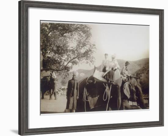 Two Well-Dressed English Women Riding on an Elephant, with the Aid of Young Indian Men-null-Framed Photographic Print