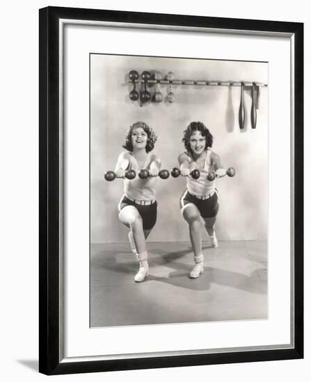 Two Women Exercising with Dumbbells at Gym-null-Framed Photo