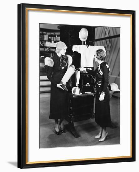 Two Women in a Store Looking at the Display-null-Framed Photo
