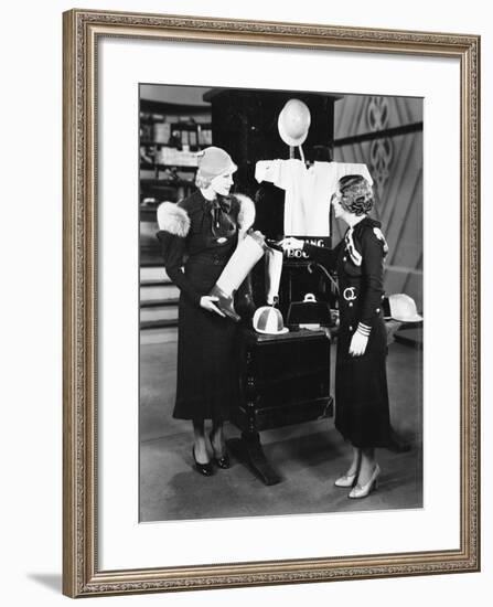 Two Women in a Store Looking at the Display-null-Framed Photo