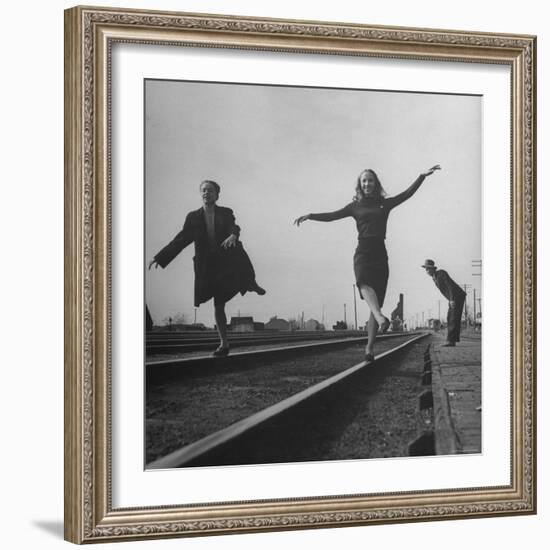 Two Young Ballet Russe Dancers Balancing on the Railroad Tracks in the Station While on Tour-Myron Davis-Framed Photographic Print