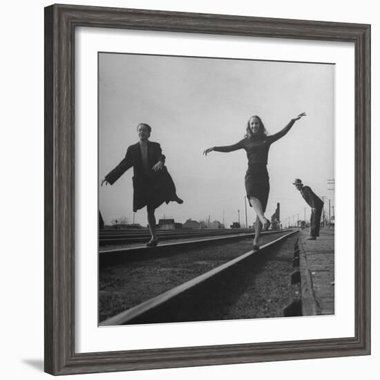 Two Young Ballet Russe Dancers Balancing on the Railroad Tracks in the Station While on Tour-Myron Davis-Framed Photographic Print