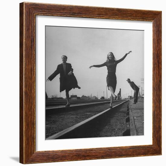 Two Young Ballet Russe Dancers Balancing on the Railroad Tracks in the Station While on Tour-Myron Davis-Framed Photographic Print