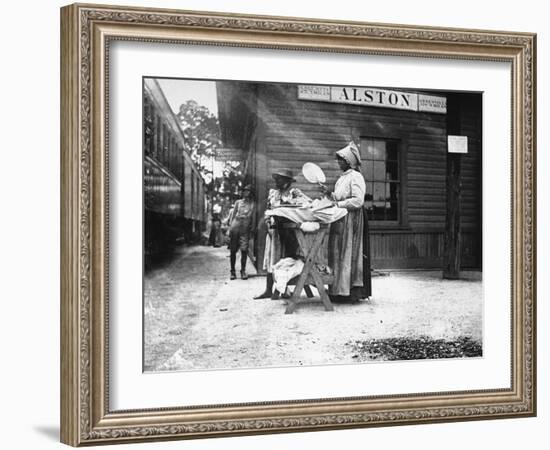 Two Young Black Women Selling Cakes at Alston Railroad Station, Next to a Train That Has Stopped-Wallace G^ Levison-Framed Photographic Print