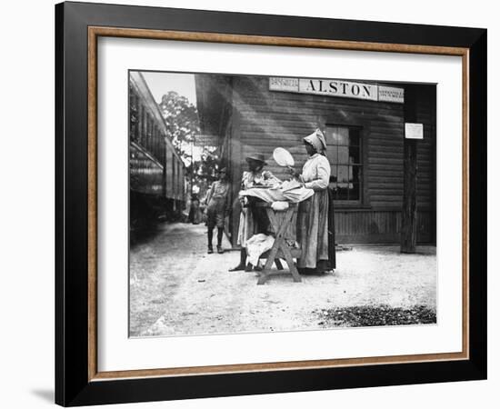 Two Young Black Women Selling Cakes at Alston Railroad Station, Next to a Train That Has Stopped-Wallace G^ Levison-Framed Photographic Print