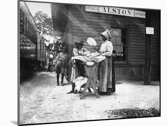 Two Young Black Women Selling Cakes at Alston Railroad Station, Next to a Train That Has Stopped-Wallace G^ Levison-Mounted Photographic Print