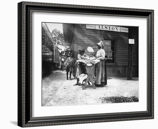 Two Young Black Women Selling Cakes at Alston Railroad Station, Next to a Train That Has Stopped-Wallace G^ Levison-Framed Photographic Print