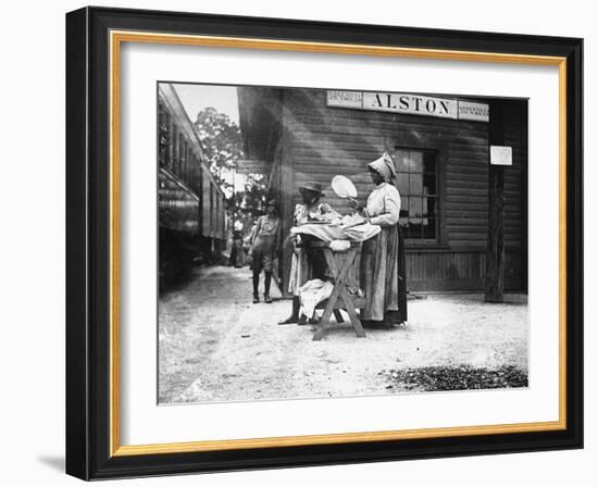 Two Young Black Women Selling Cakes at Alston Railroad Station, Next to a Train That Has Stopped-Wallace G^ Levison-Framed Photographic Print