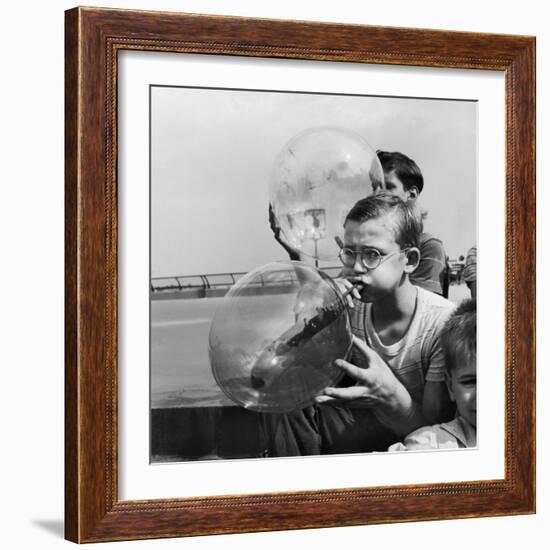 Two Young Boys Blowing Large Transparent Bubbles with a Blow-Straw Dipped in a Soft Plastic-Alfred Eisenstaedt-Framed Photographic Print
