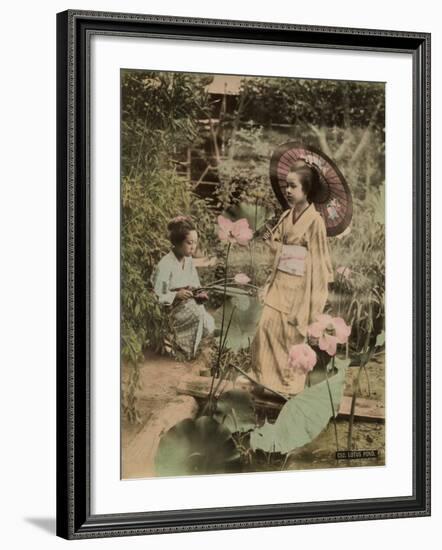 Two Young Japanese Girls, One Holding a Parasol, with Lotus Flowers-null-Framed Photographic Print