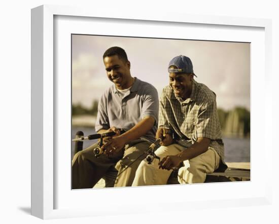 Two Young Men Sitting on The Pier Fishing-null-Framed Photographic Print