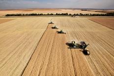 Four Harvesters Combing on a Prairie Landscape in Formation-Tyler Olson-Framed Photographic Print