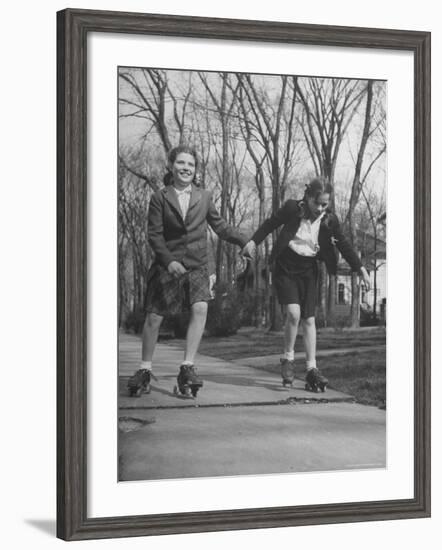 Typical 10 Year Old Girls Known as "Pigtailers" Roller Skating-Frank Scherschel-Framed Photographic Print