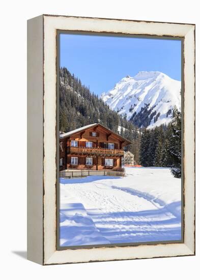 Typical wooden hut framed by woods and snowy peaks, Langwies, district of Plessur, Canton of Graubu-Roberto Moiola-Framed Premier Image Canvas