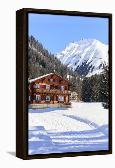 Typical wooden hut framed by woods and snowy peaks, Langwies, district of Plessur, Canton of Graubu-Roberto Moiola-Framed Premier Image Canvas