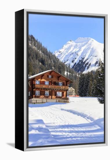 Typical wooden hut framed by woods and snowy peaks, Langwies, district of Plessur, Canton of Graubu-Roberto Moiola-Framed Premier Image Canvas
