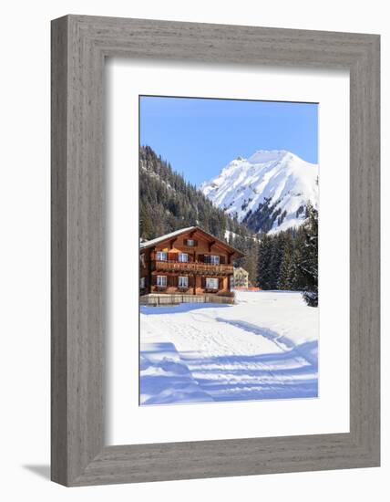 Typical wooden hut framed by woods and snowy peaks, Langwies, district of Plessur, Canton of Graubu-Roberto Moiola-Framed Photographic Print