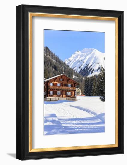 Typical wooden hut framed by woods and snowy peaks, Langwies, district of Plessur, Canton of Graubu-Roberto Moiola-Framed Photographic Print
