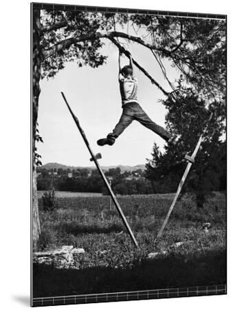 Kenneth Merriman Swinging on Tree Limb After Kicking Away 