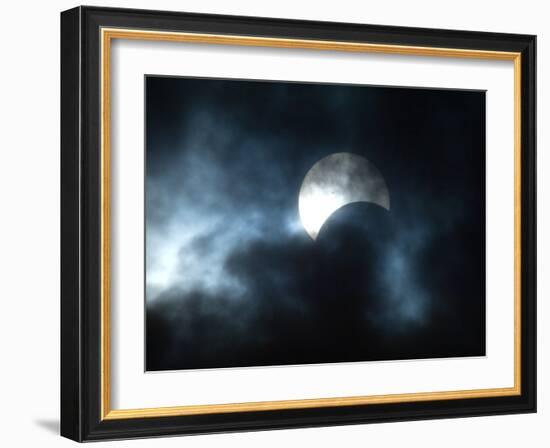 Seen Through Clouds the Sun is Partially Obscured by the Moon During an Eclipse-null-Framed Photographic Print