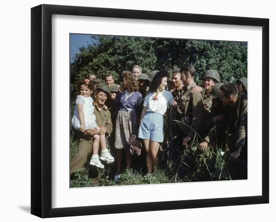 U.S. Soldiers Gather around a French Girl Near Avranches, France, August 1944-Frank Scherschel-Framed Photographic Print