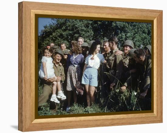 U.S. Soldiers Gather around a French Girl Near Avranches, France, August 1944-Frank Scherschel-Framed Premier Image Canvas