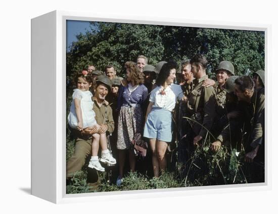 U.S. Soldiers Gather around a French Girl Near Avranches, France, August 1944-Frank Scherschel-Framed Premier Image Canvas