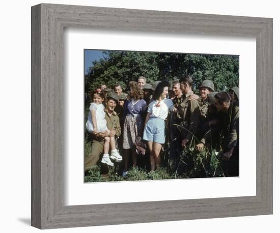 U.S. Soldiers Gather around a French Girl Near Avranches, France, August 1944-Frank Scherschel-Framed Photographic Print