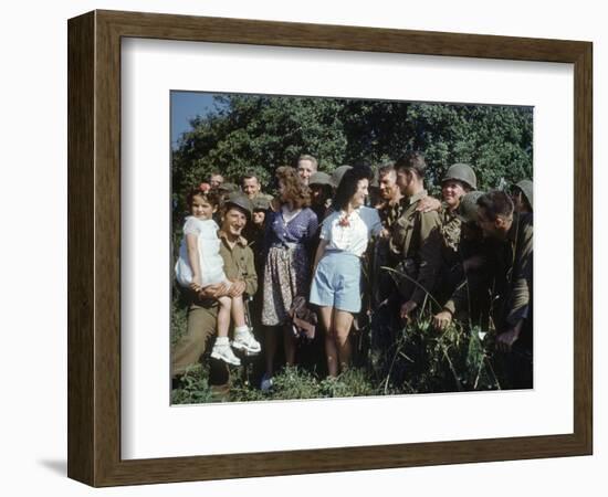 U.S. Soldiers Gather around a French Girl Near Avranches, France, August 1944-Frank Scherschel-Framed Photographic Print