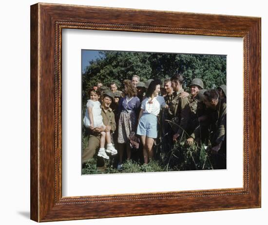 U.S. Soldiers Gather around a French Girl Near Avranches, France, August 1944-Frank Scherschel-Framed Photographic Print