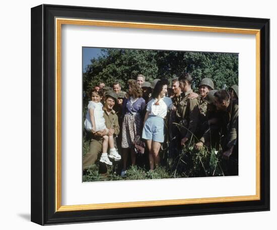 U.S. Soldiers Gather around a French Girl Near Avranches, France, August 1944-Frank Scherschel-Framed Photographic Print