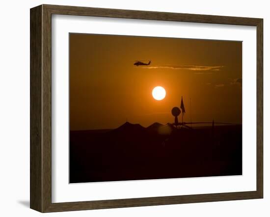 UH-60 Blackhawk Flies over Camp Speicher Airfield at Sunset-Stocktrek Images-Framed Photographic Print