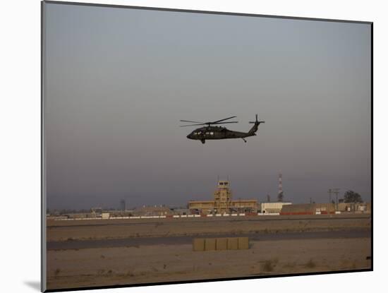 UH-60 Blackhawk Helicopter Flies Past the Tower on Camp Speicher-Stocktrek Images-Mounted Photographic Print