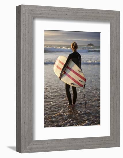 Uk, Cornwall, Polzeath. a Woman Looks Out to See, Preparing for an Evening Surf. Mr-Niels Van Gijn-Framed Photographic Print