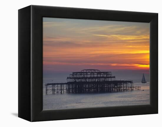 UK, England, Sussex, Brighton, Boat Sailing Past Remains of Brighton West Pier at Sunset-Jane Sweeney-Framed Premier Image Canvas