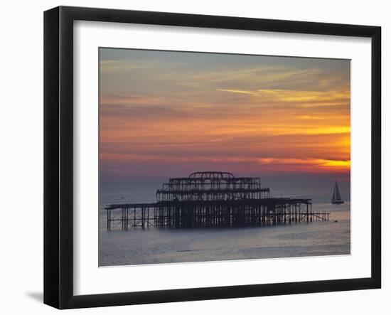 UK, England, Sussex, Brighton, Boat Sailing Past Remains of Brighton West Pier at Sunset-Jane Sweeney-Framed Photographic Print