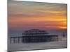 UK, England, Sussex, Brighton, Boat Sailing Past Remains of Brighton West Pier at Sunset-Jane Sweeney-Mounted Photographic Print