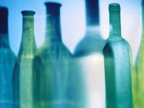 A Glass of White Wine and Wine Bottles in Background-Ulrike Koeb-Photographic Print